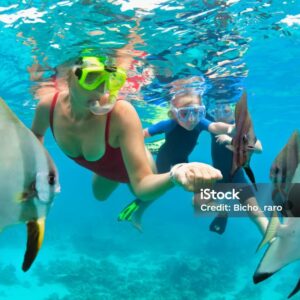 Happy family - mother, kids in snorkeling mask dive underwater, explore tropical fishes in coral reef sea pool. Travel active lifestyle, beach adventure, swimming activity on summer holiday with child